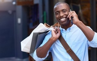 Portrait of a stylish young man shopping in the city