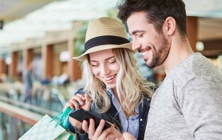 Couple shopping uses smartphone app