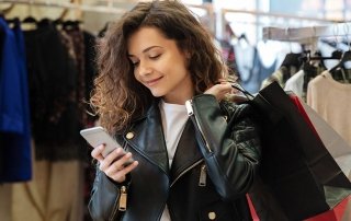 Cheerful curly young lady chatting by phone