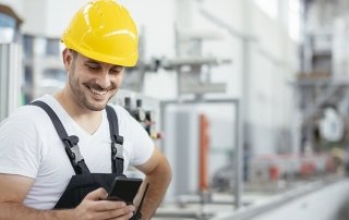 Factory worker in uniform with phone