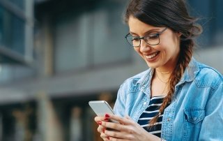 Young woman on smart phone city